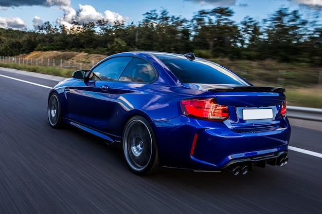 blue-car-driving-road_114579-4056